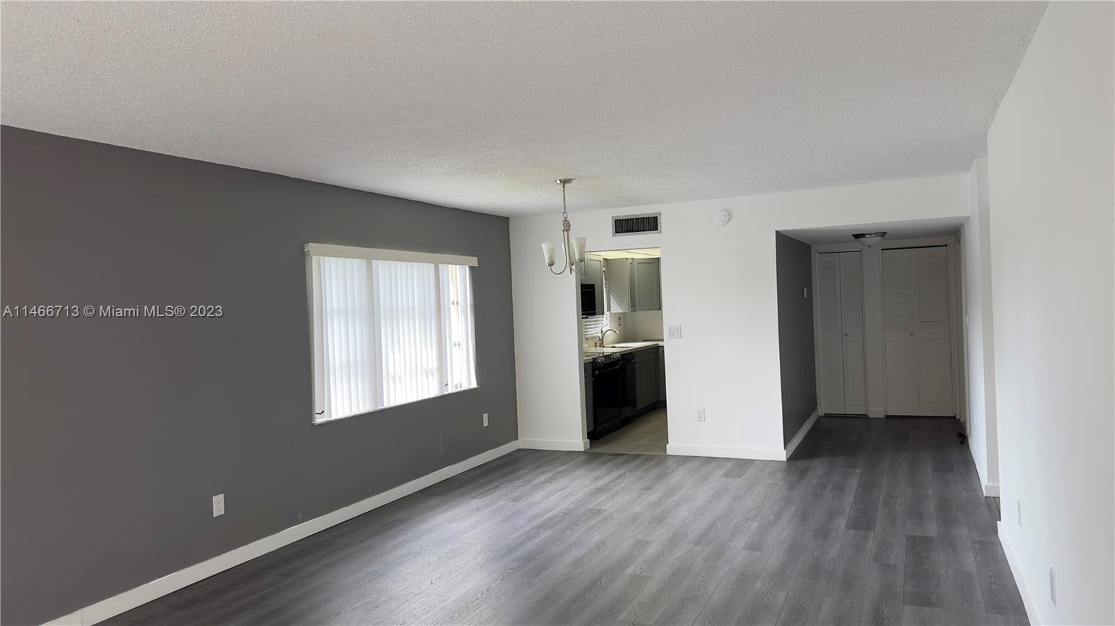 California Club Miami, FL 33179 - Photo 25 of 40 a view of an empty room with a window and wooden floor