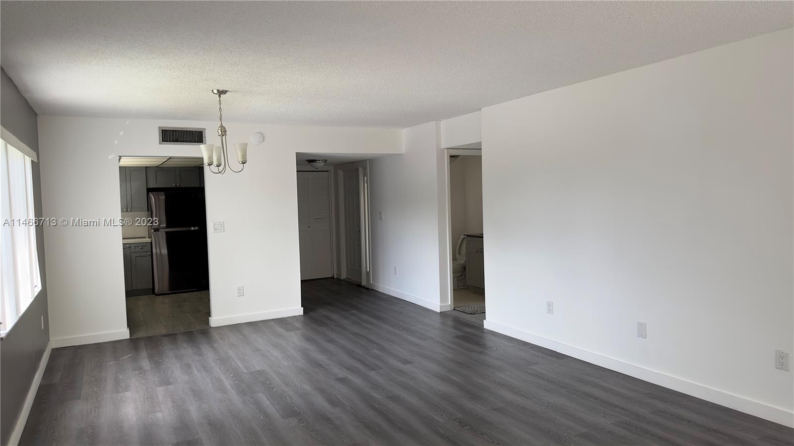 California Club Miami, FL 33179 - Photo 28 of 40 a view of empty room with wooden floor and window