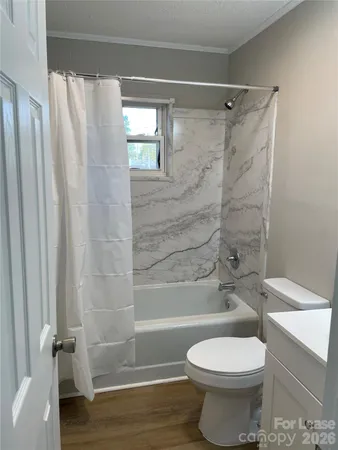 a bathroom with a toilet and shower