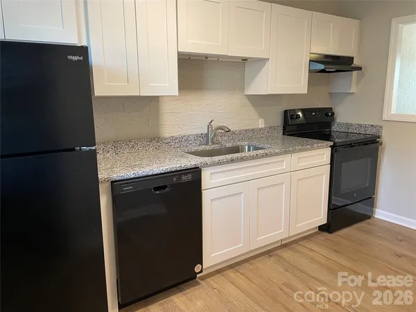 a kitchen with a sink and a refrigerator