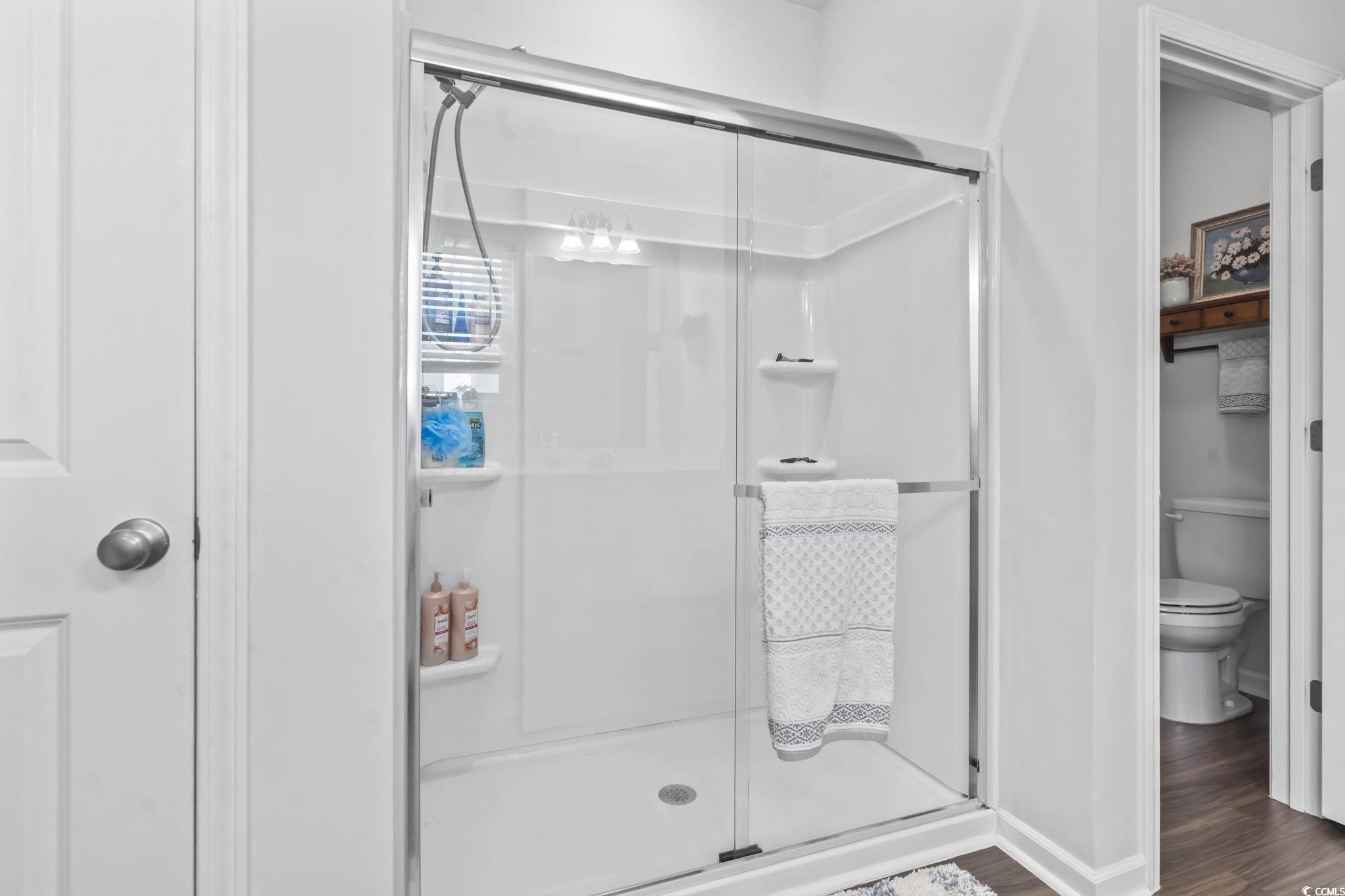 1310 Boswell Court Conway, SC 29526 - Photo 11 of 35 Bathroom featuring dark wood-style floors and a stall shower
