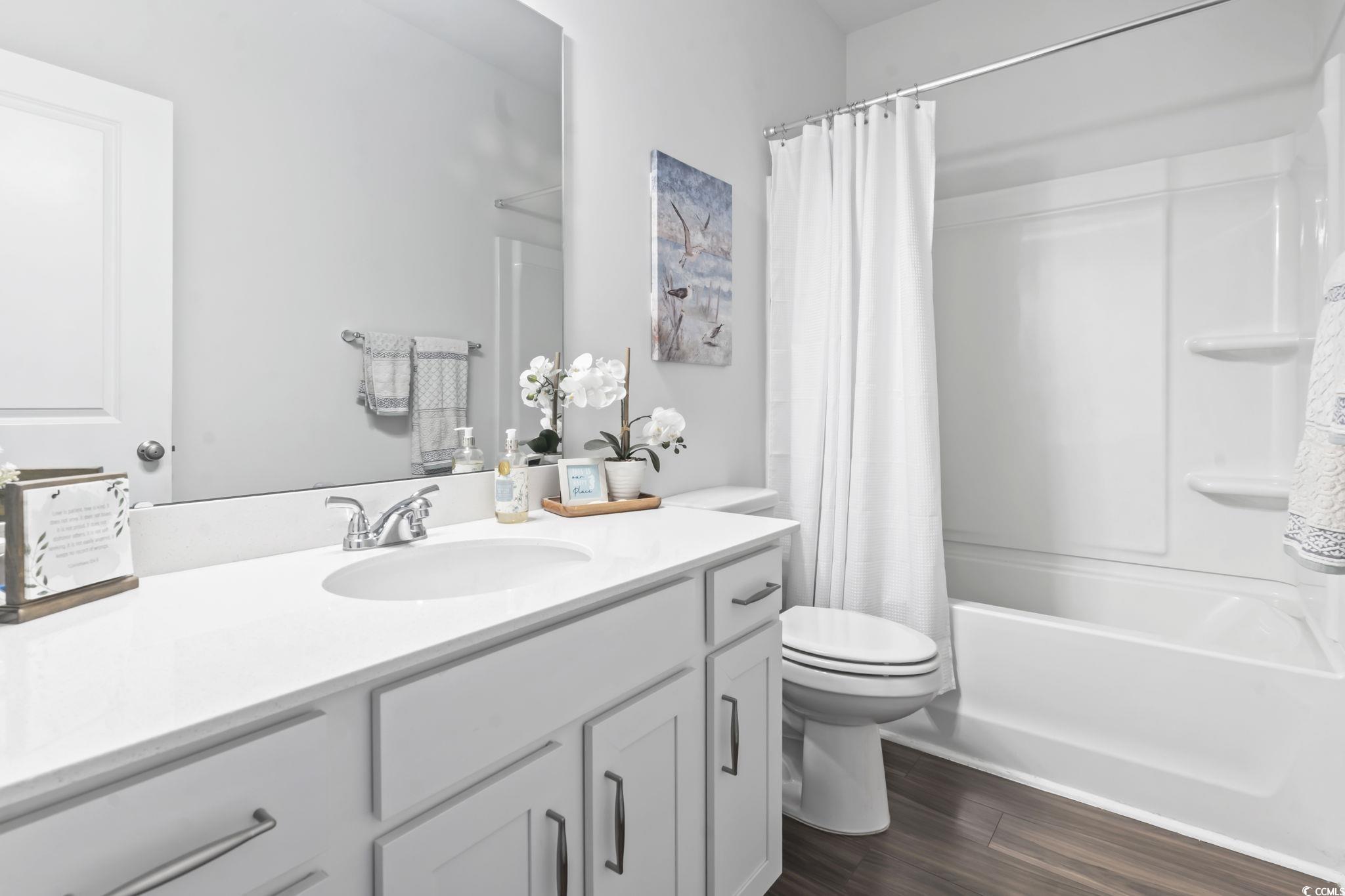 1310 Boswell Court Conway, SC 29526 - Photo 13 of 35 Full bathroom with dark wood-style flooring, vanity, and shower / bath combo with shower curtain