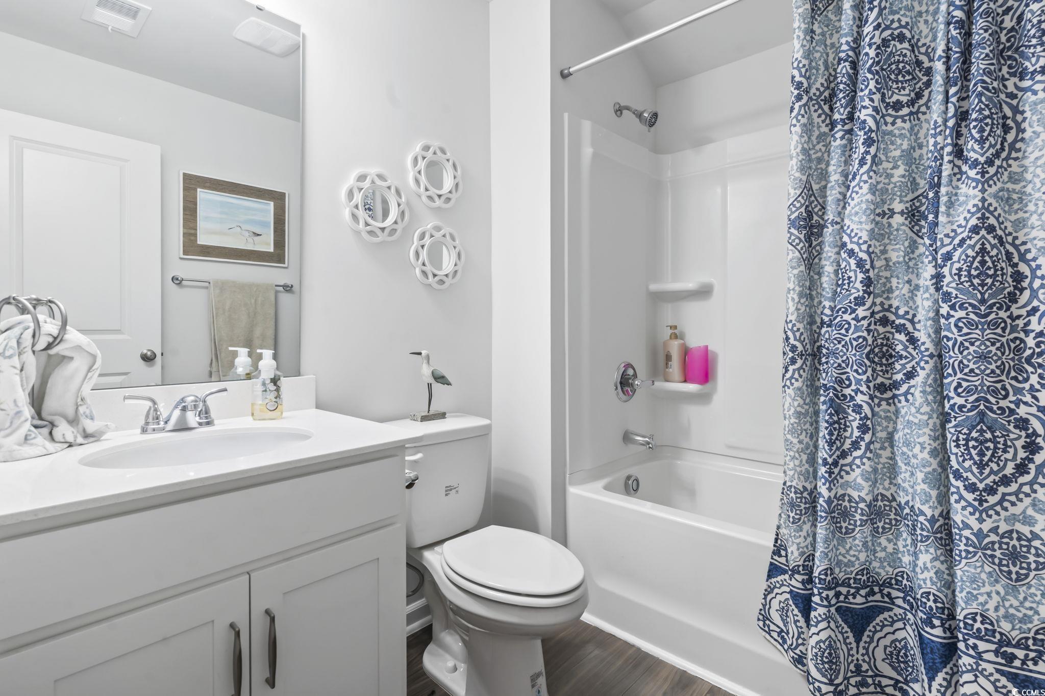 1310 Boswell Court Conway, SC 29526 - Photo 17 of 35 Full bath featuring vanity, shower / bath combination with curtain, and dark wood-style flooring