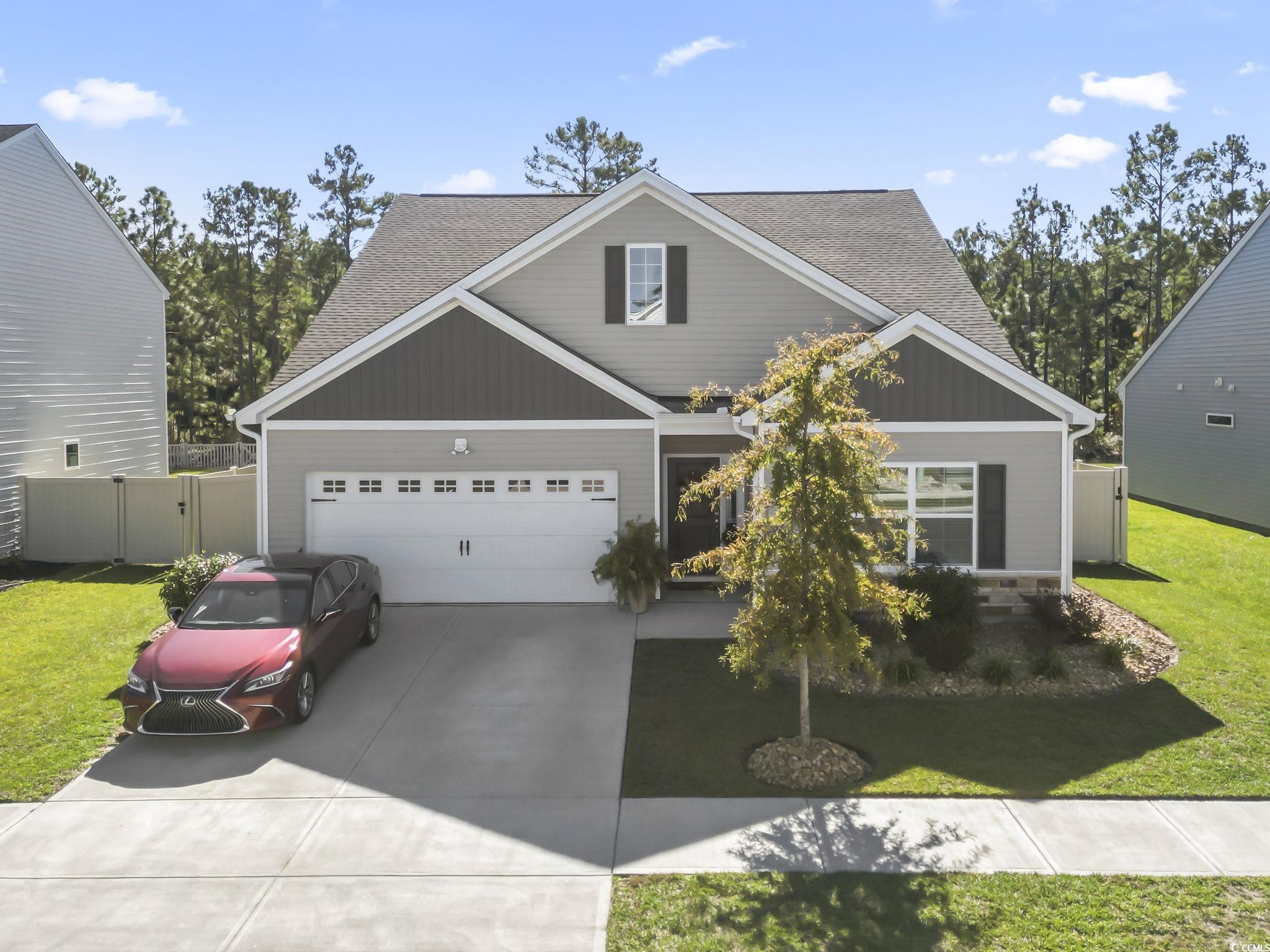 1310 Boswell Court Conway, SC 29526 - Photo 34 of 35 Craftsman inspired home featuring roof with shingles, concrete driveway, an attached garage, and a gate