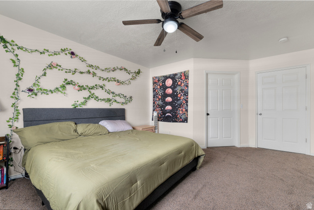 25 West Ridge Road, Unit 25 Saratoga Springs, UT 84045 - Photo 12 of 22 Carpeted room featuring a ceiling fan with integrated lighting, a substantial bed frame with an upholstered headboard, and two six-panel interior doors