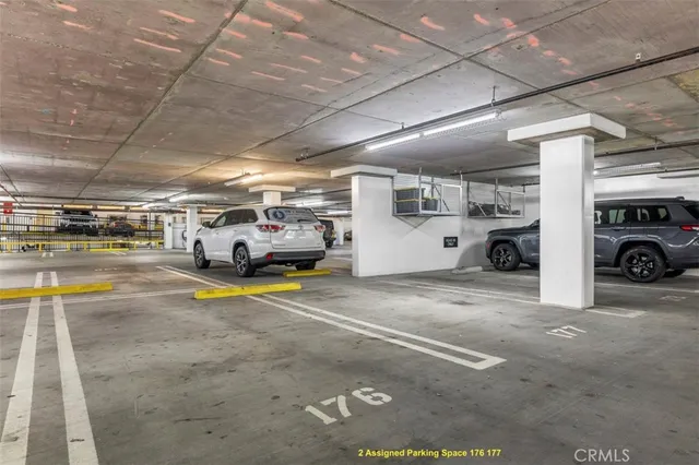 a view of parking garage with cars parked