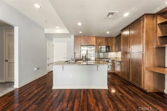 a kitchen with a refrigerator and white cabinets