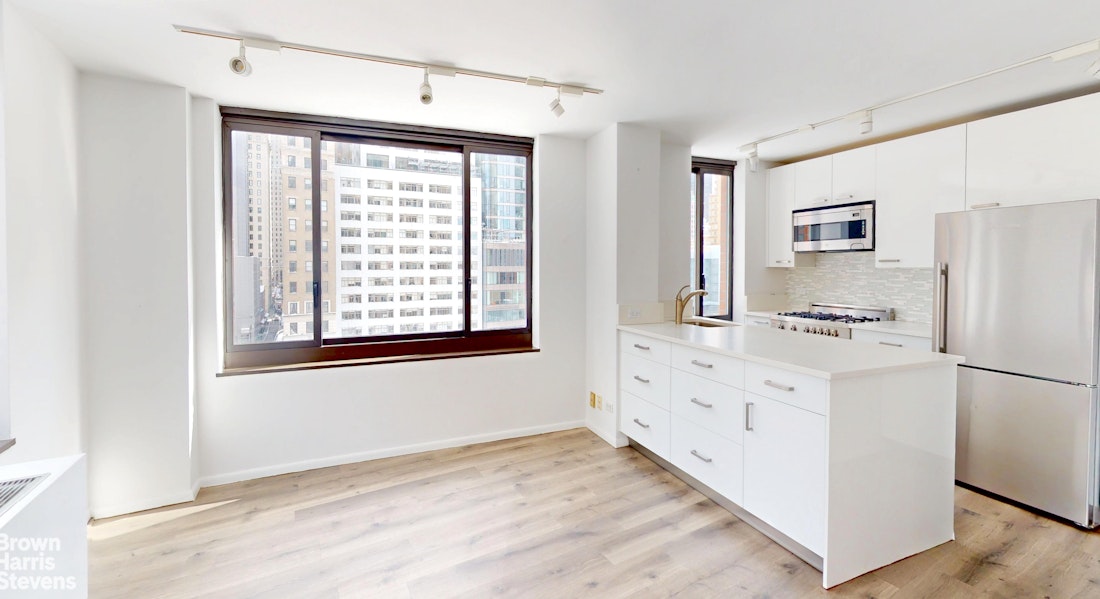 200 Rector Place, Unit 8U Manhattan, NY 10280 - Photo 10 of 25 a kitchen with granite countertop a refrigerator and a stove top oven