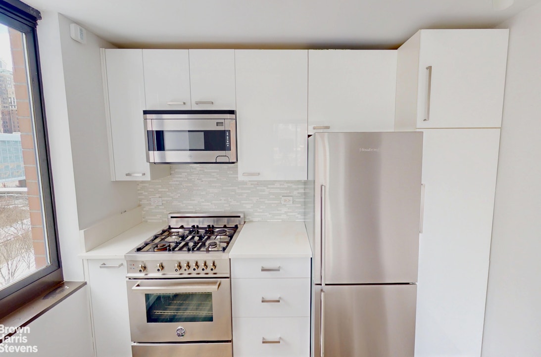 200 Rector Place, Unit 8U Manhattan, NY 10280 - Photo 13 of 25 a kitchen with a refrigerator stove and microwave