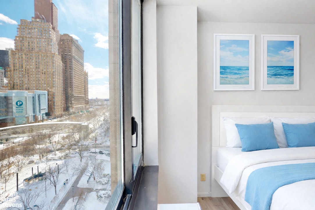 200 Rector Place, Unit 8U Manhattan, NY 10280 - Photo 14 of 25 a bedroom with a bed and a window