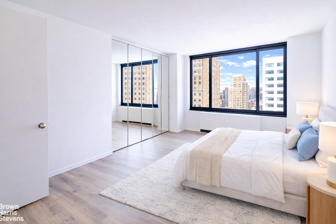 200 Rector Place, Unit 8U Manhattan, NY 10280 - Photo 16 of 25 a bedroom with a large bed and windows