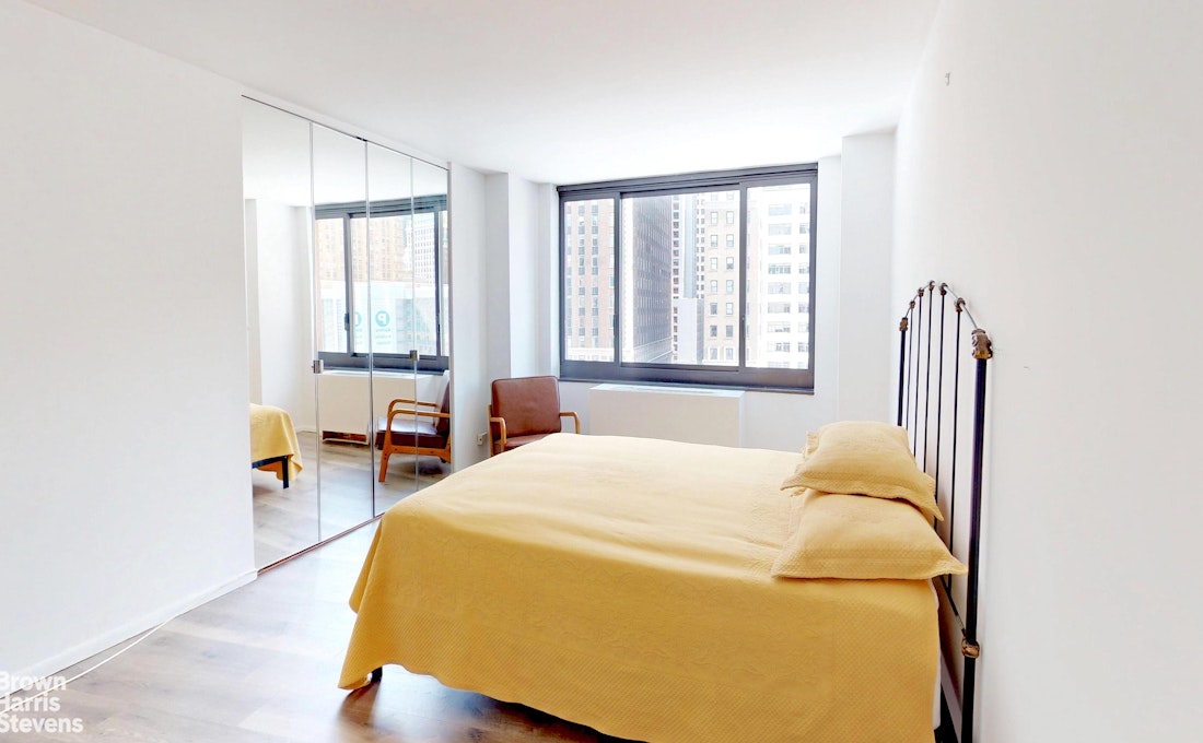 200 Rector Place, Unit 8U Manhattan, NY 10280 - Photo 17 of 25 a bedroom with a bed and a window