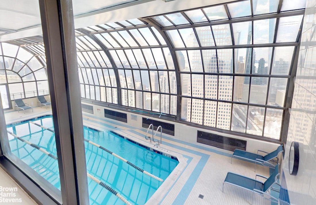 200 Rector Place, Unit 8U Manhattan, NY 10280 - Photo 20 of 25 a view of an empty room with wooden floor and furniture