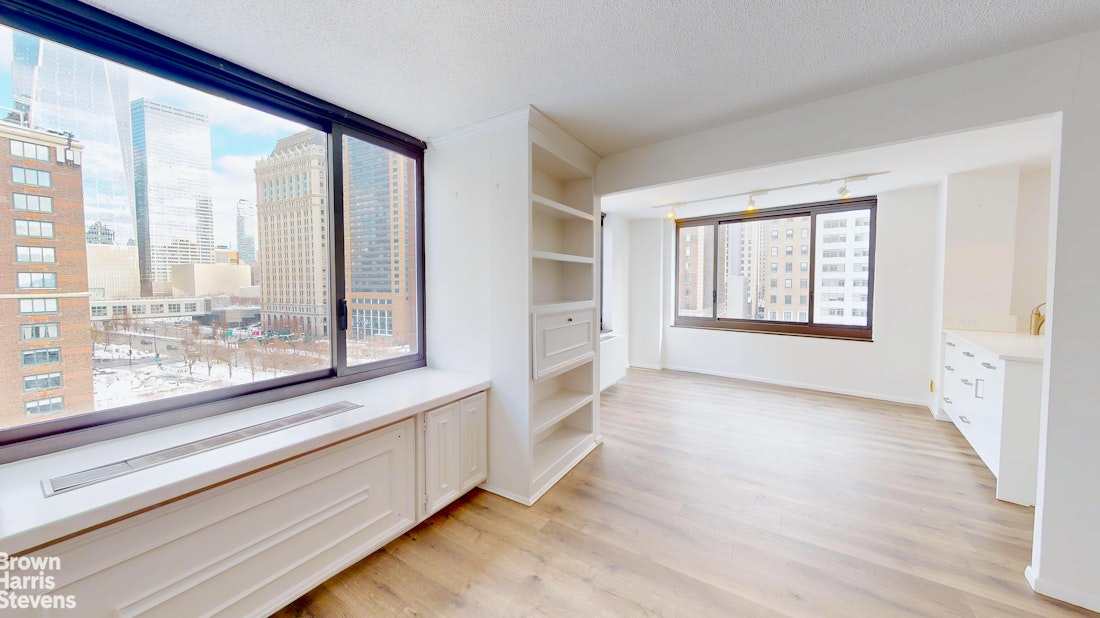 200 Rector Place, Unit 8U Manhattan, NY 10280 - Photo 5 of 25 a view of an empty room with a window and wooden floor