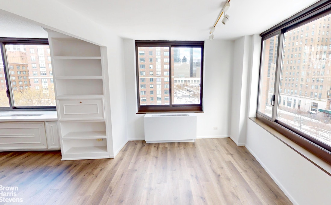 200 Rector Place, Unit 8U Manhattan, NY 10280 - Photo 9 of 25 a view of an empty room with a window and wooden floor