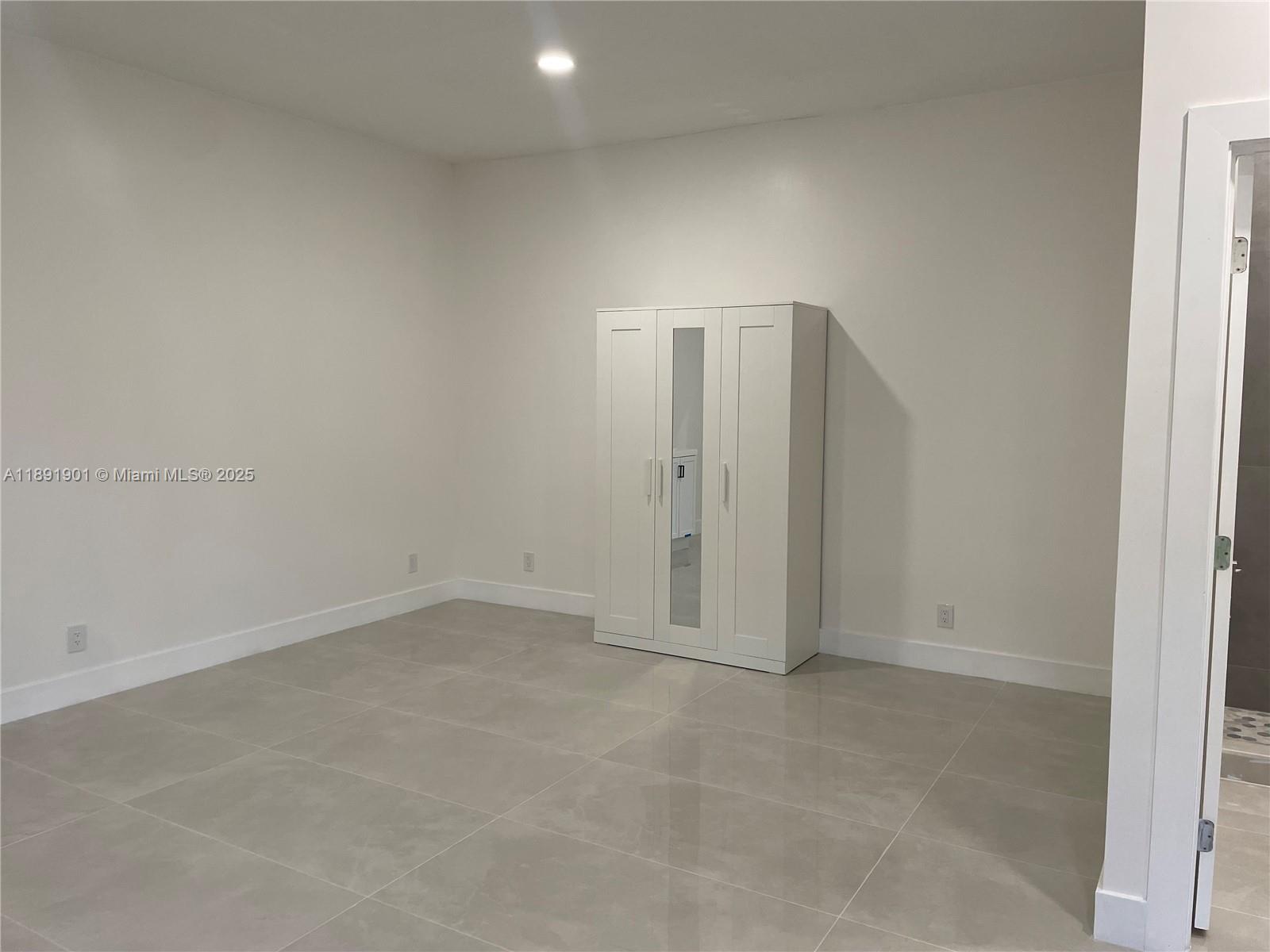 30778 Southwest 192nd Avenue, Unit 1 Homestead, FL 33030 - Photo 2 of 10 an empty room with closet area