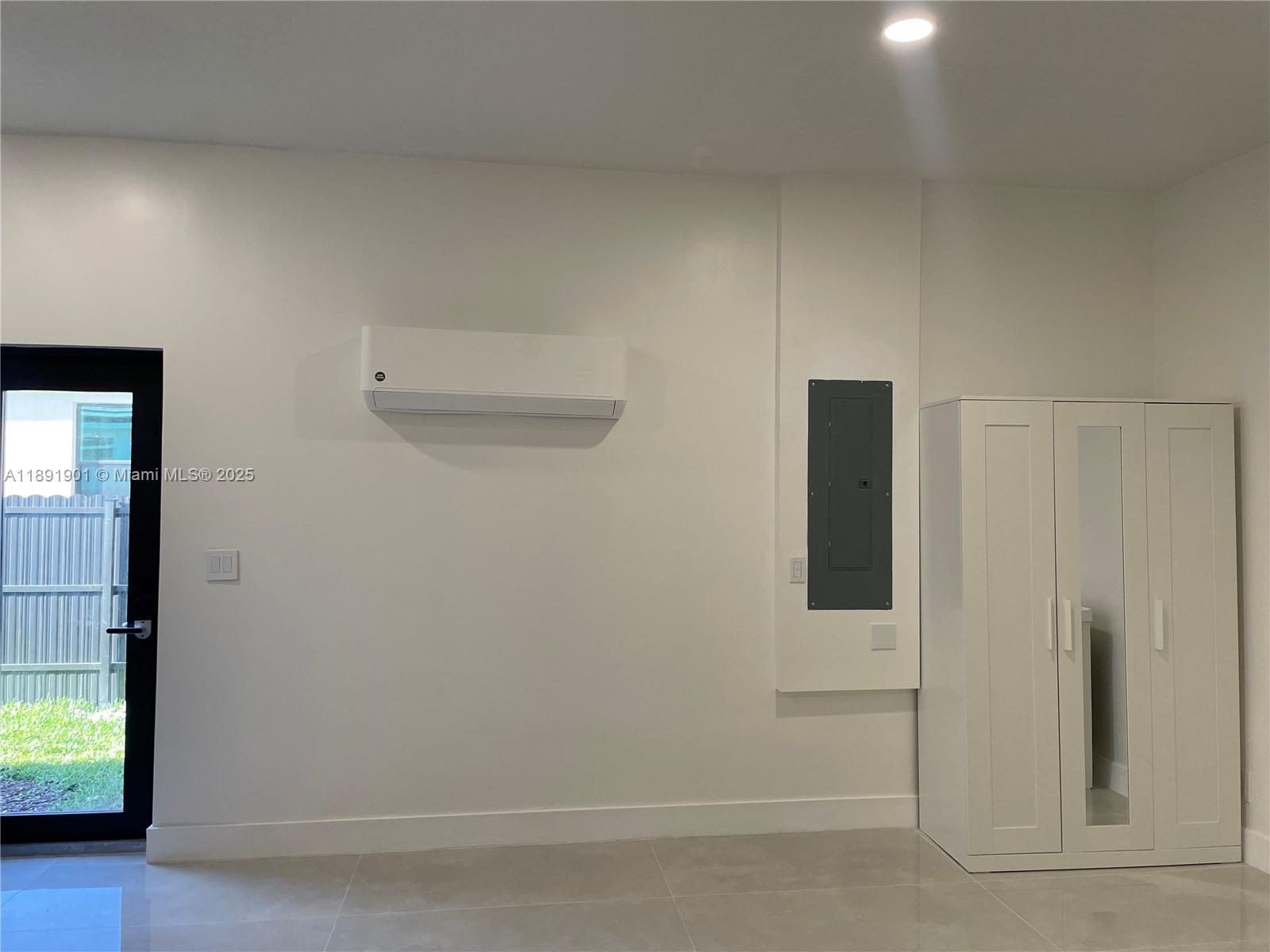 30778 Southwest 192nd Avenue, Unit 1 Homestead, FL 33030 - Photo 3 of 10 an empty room with windows