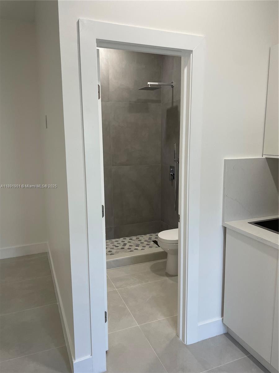 30778 Southwest 192nd Avenue, Unit 1 Homestead, FL 33030 - Photo 5 of 10 a bathroom with a granite countertop sink