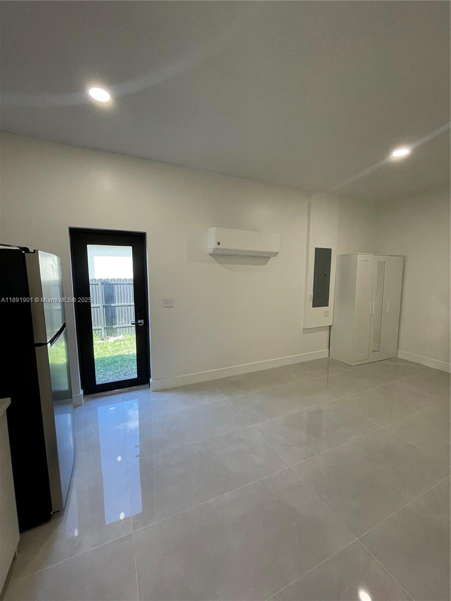 30778 Southwest 192nd Avenue, Unit 1 Homestead, FL 33030 - Photo 7 of 10 a view of an empty room with a fireplace