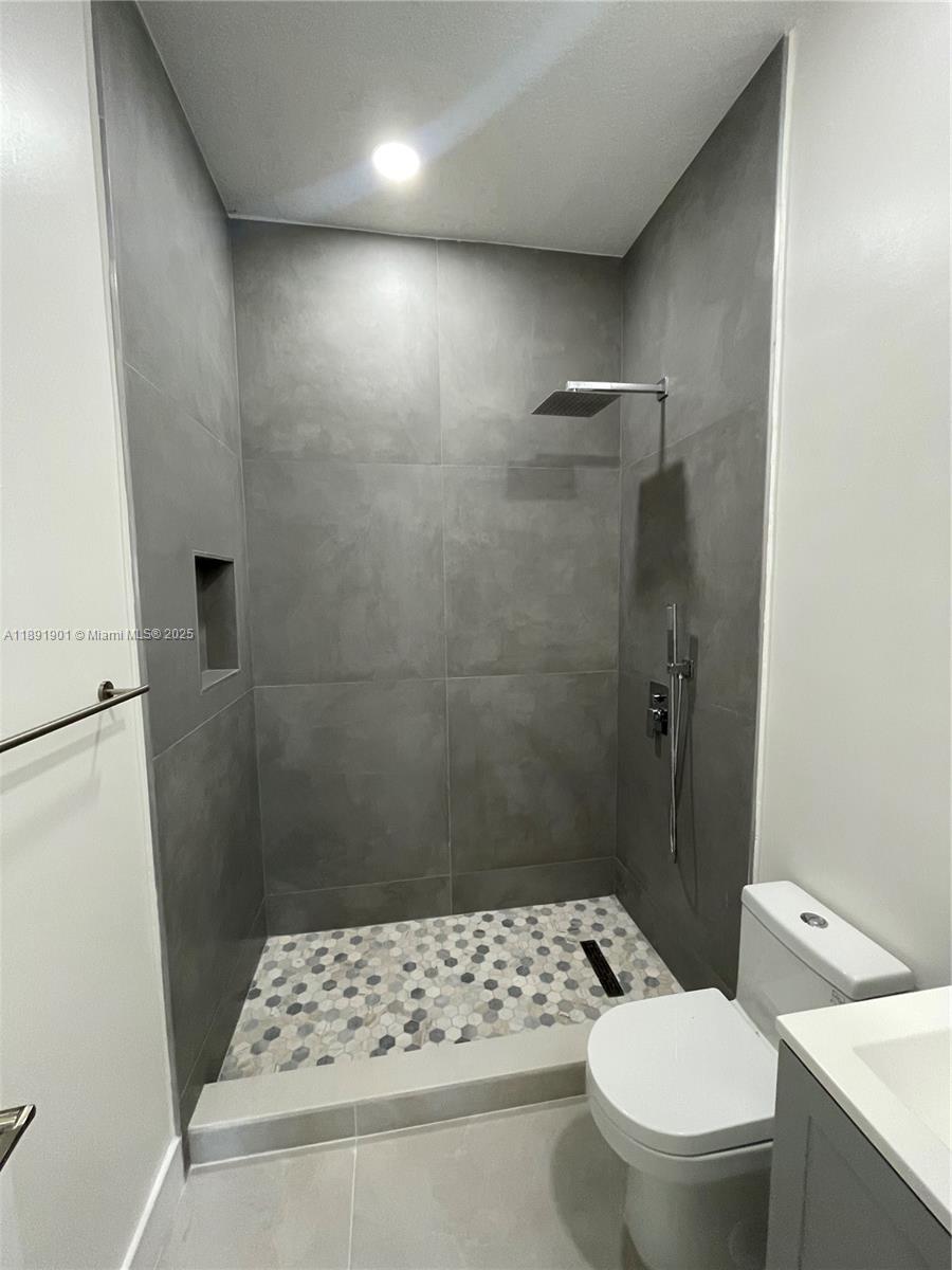 30778 Southwest 192nd Avenue, Unit 1 Homestead, FL 33030 - Photo 9 of 10 a bathroom with a toilet a sink and shower