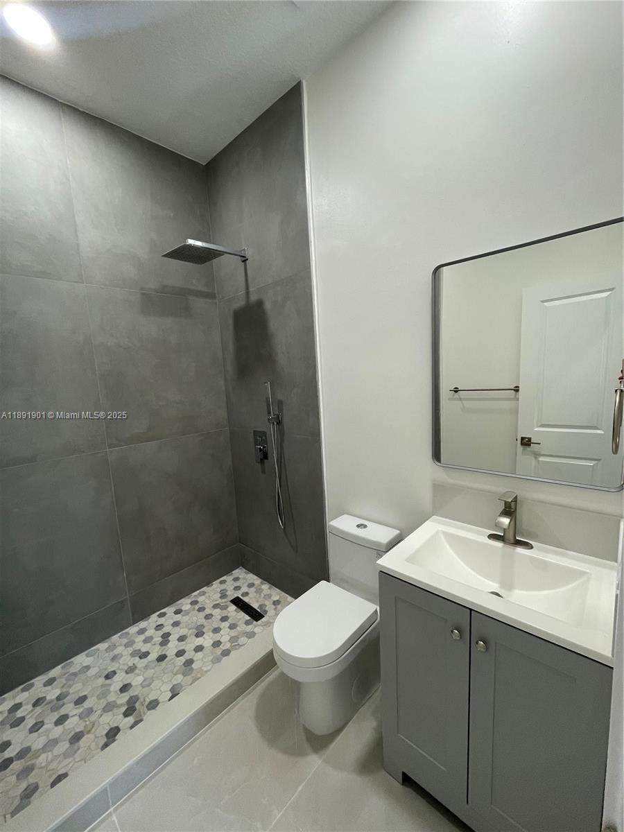 30778 Southwest 192nd Avenue, Unit 1 Homestead, FL 33030 - Photo 10 of 10 a bathroom with a sink a toilet and shower