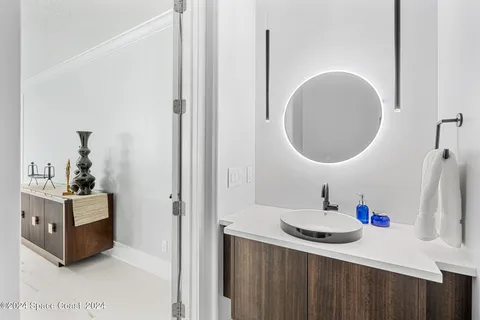 a bathroom with a sink a vanity and a mirror