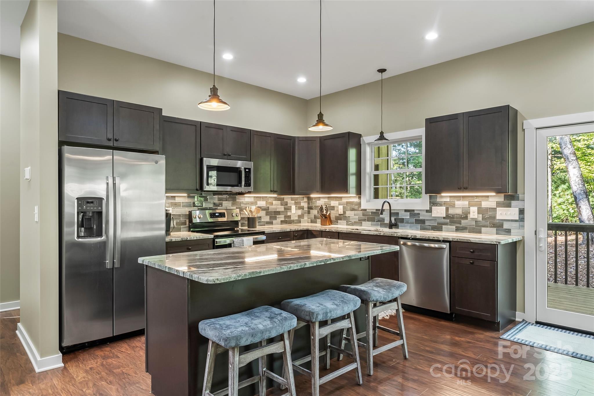 90 Clinchfield Gap Road Marion, NC 28752 - Photo 12 of 42 a kitchen with stainless steel appliances granite countertop a kitchen island hardwood floor and a sink