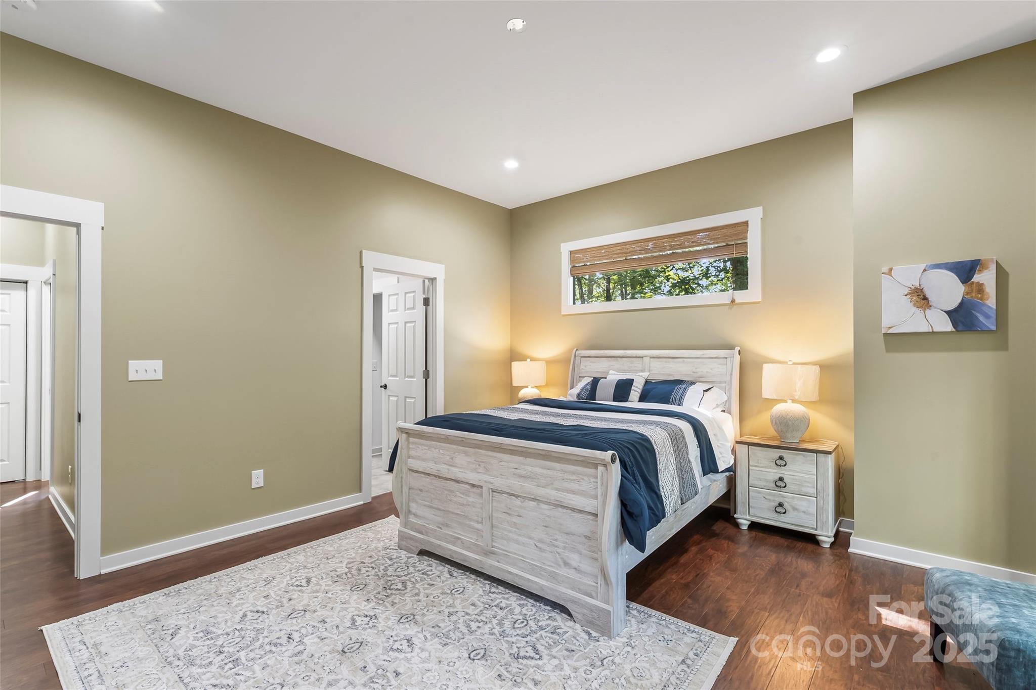 90 Clinchfield Gap Road Marion, NC 28752 - Photo 18 of 42 a spacious bedroom with a bed and a painting on the wall