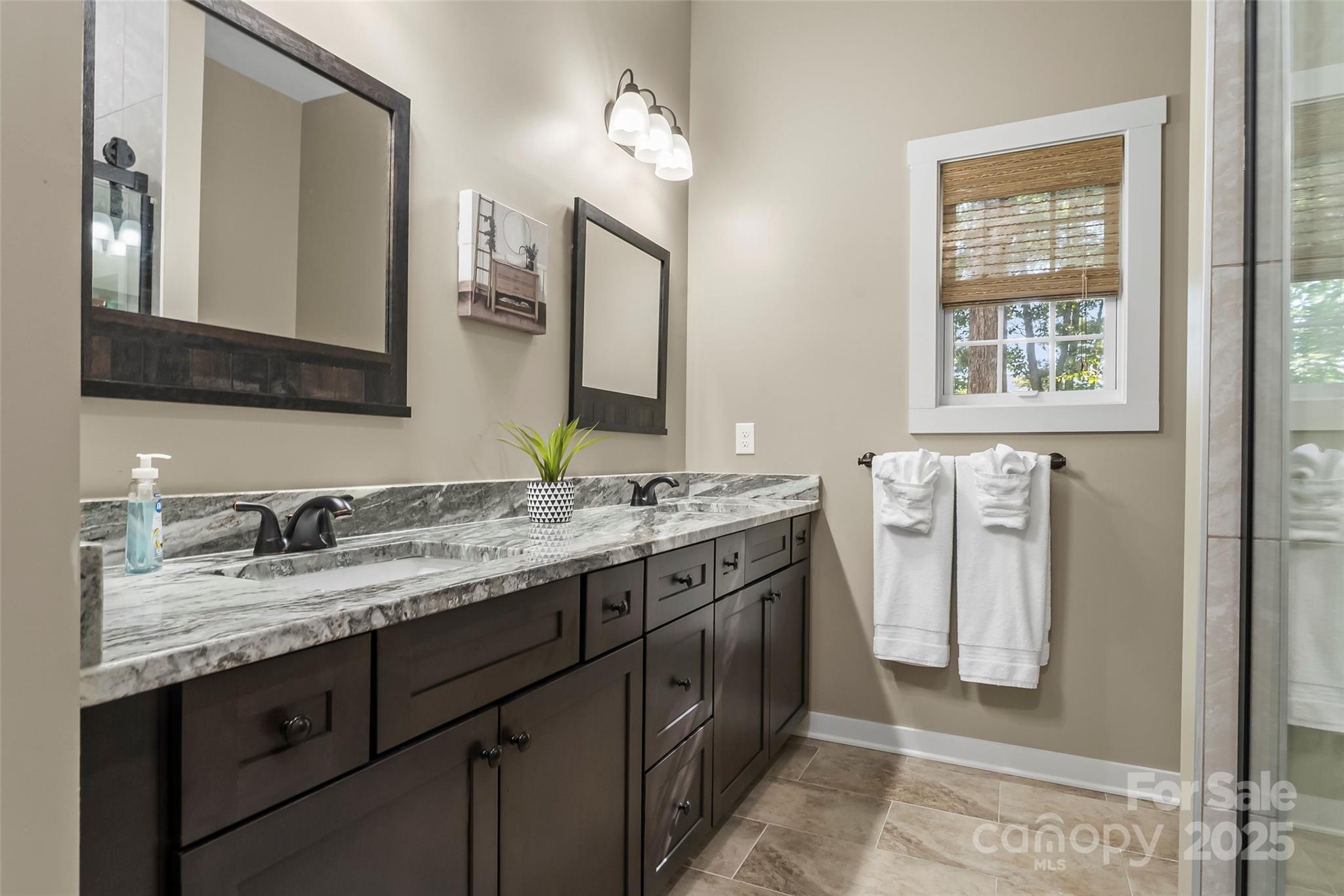 90 Clinchfield Gap Road Marion, NC 28752 - Photo 20 of 42 a bathroom with a granite countertop sink and a mirror