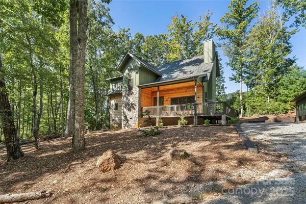 a view of a house with a tree in the background