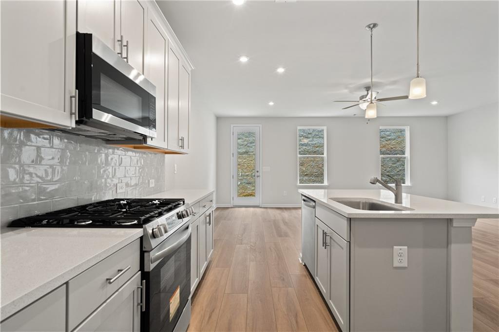 710 Smokey Quartz Way Kennesaw, GA 30144 - Photo 13 of 31 a kitchen with stainless steel appliances a sink a stove and cabinets