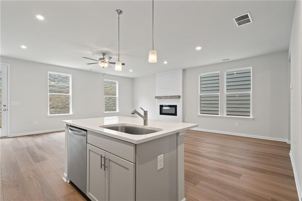 710 Smokey Quartz Way Kennesaw, GA 30144 - Photo 14 of 31 a kitchen with a sink chandelier and wooden floor