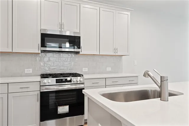 a kitchen with a sink and a stove top oven