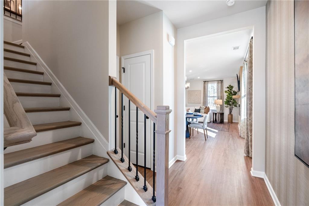 710 Smokey Quartz Way Kennesaw, GA 30144 - Photo 41 of 76 a view of a hallway with wooden floor and stairs