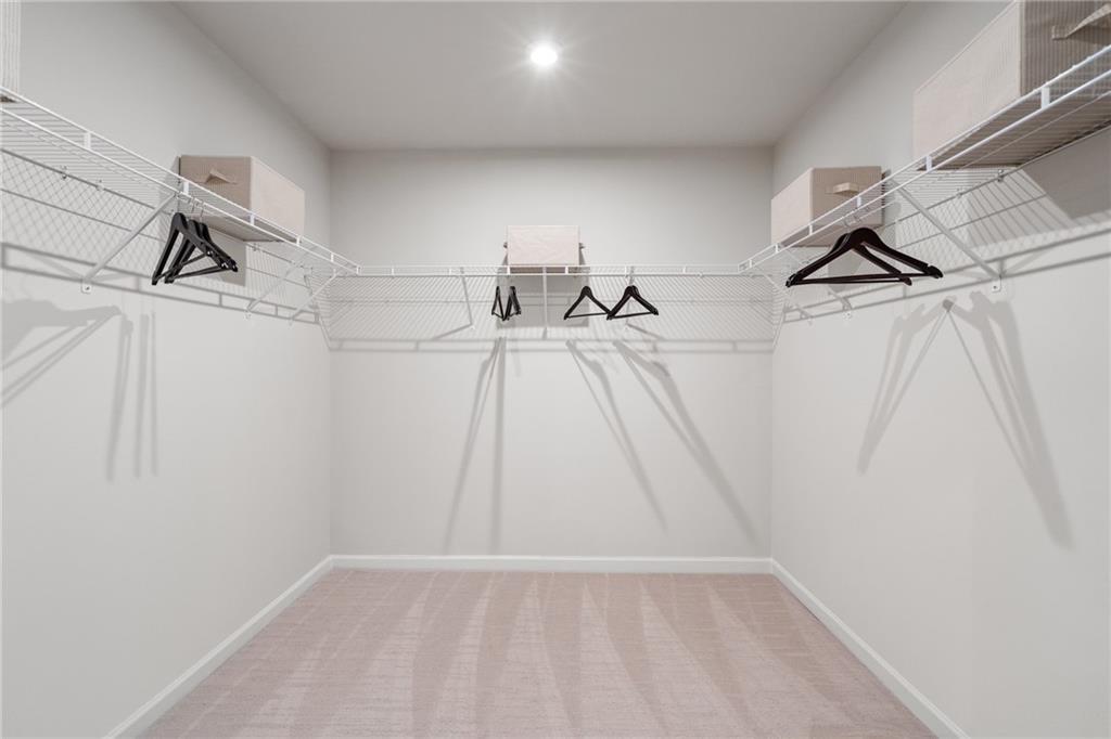 710 Smokey Quartz Way Kennesaw, GA 30144 - Photo 65 of 76 a view of walk in closet with empty racks