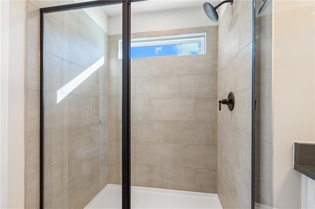 710 Smokey Quartz Way Kennesaw, GA 30144 - Photo 68 of 76 a bathroom with a glass shower door