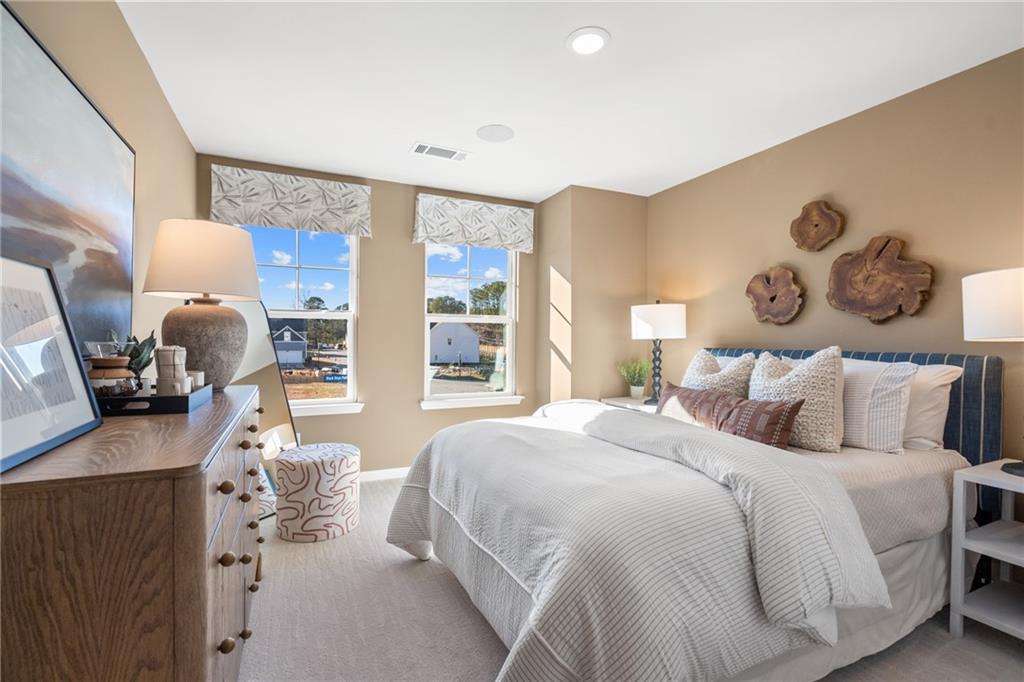 710 Smokey Quartz Way Kennesaw, GA 30144 - Photo 69 of 76 a bedroom with a large bed and a large window