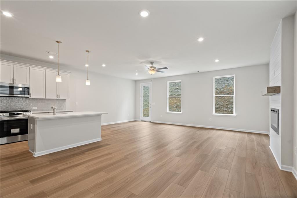 710 Smokey Quartz Way Kennesaw, GA 30144 - Photo 8 of 31 a view of an empty room with window and wooden floor