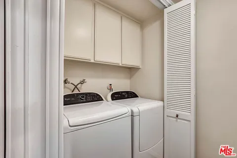 a view of storage and utility room with washer and dryer