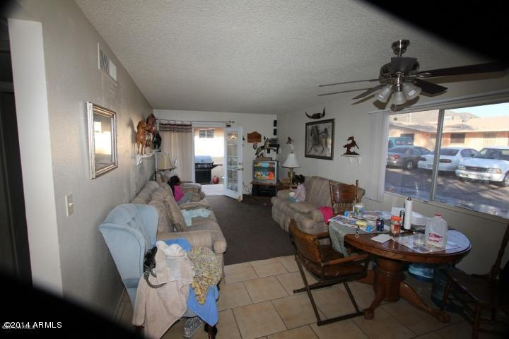 936 West Mountain View Road, Unit 14 Phoenix, AZ 85021 - Photo 8 of 10 a living room with furniture and a window