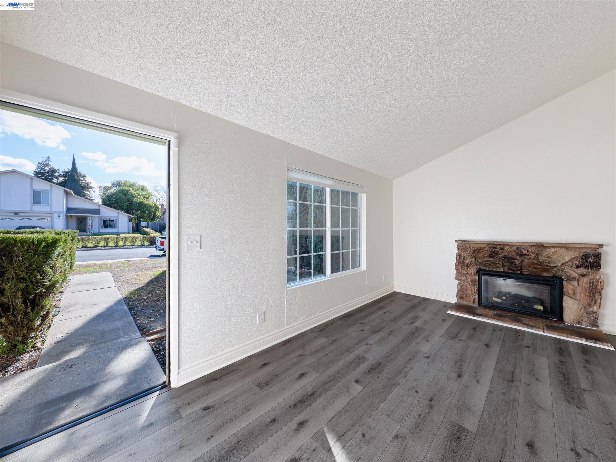 3432 Danielle Place Bay Point, CA 94565 - Photo 6 of 36 an empty room with floor to ceiling window and wooden floor