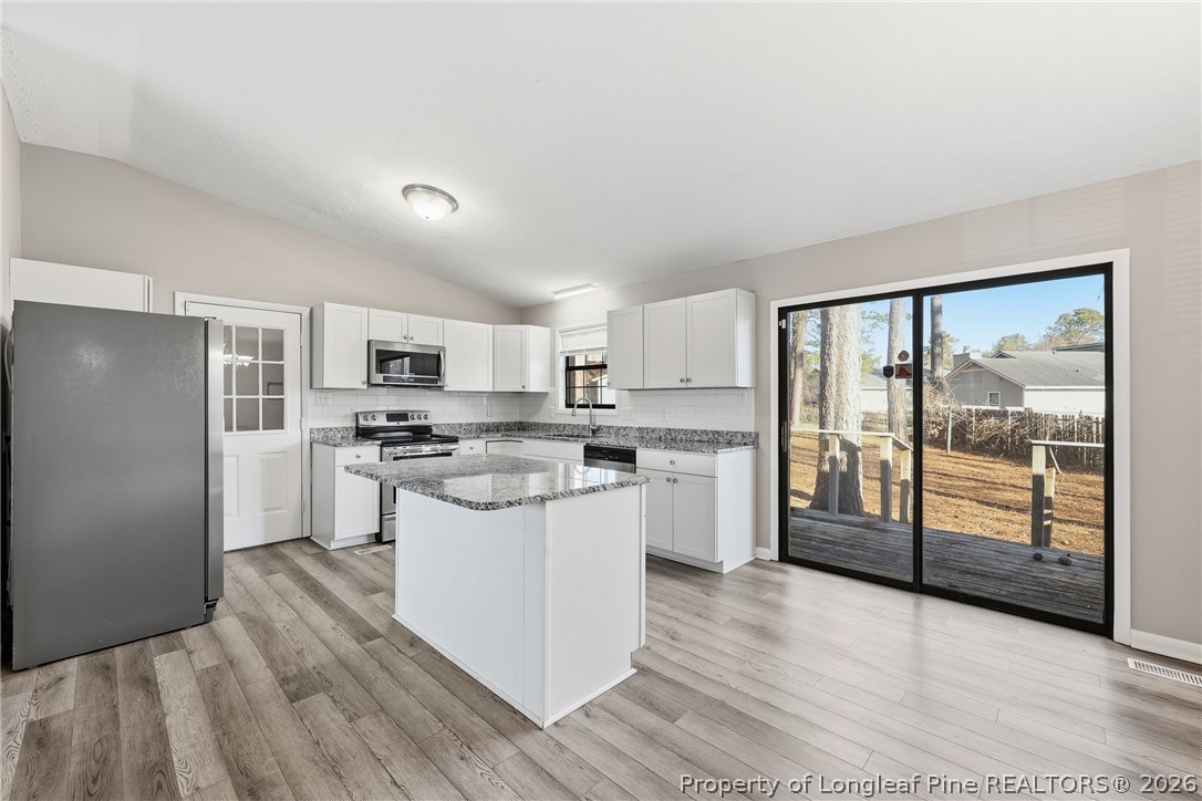 1304 Chara Court Spring Lake, NC 28390 - Photo 13 of 33 a kitchen with white cabinets and white appliances