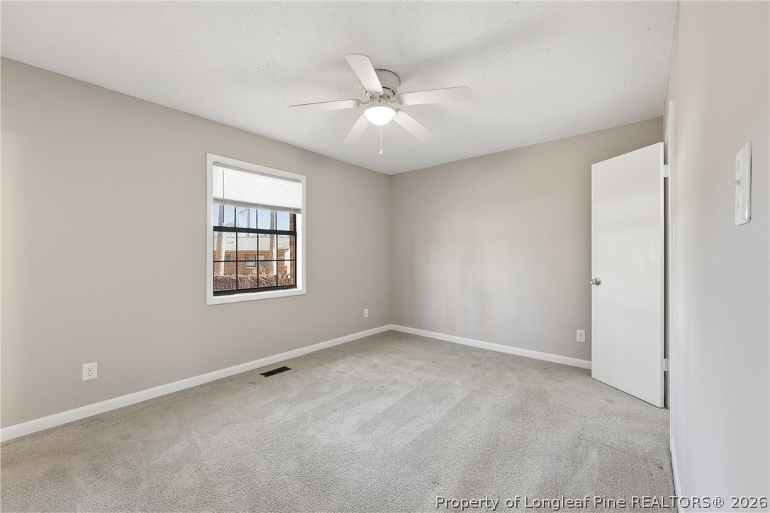 1304 Chara Court Spring Lake, NC 28390 - Photo 17 of 33 an empty room with windows and fan