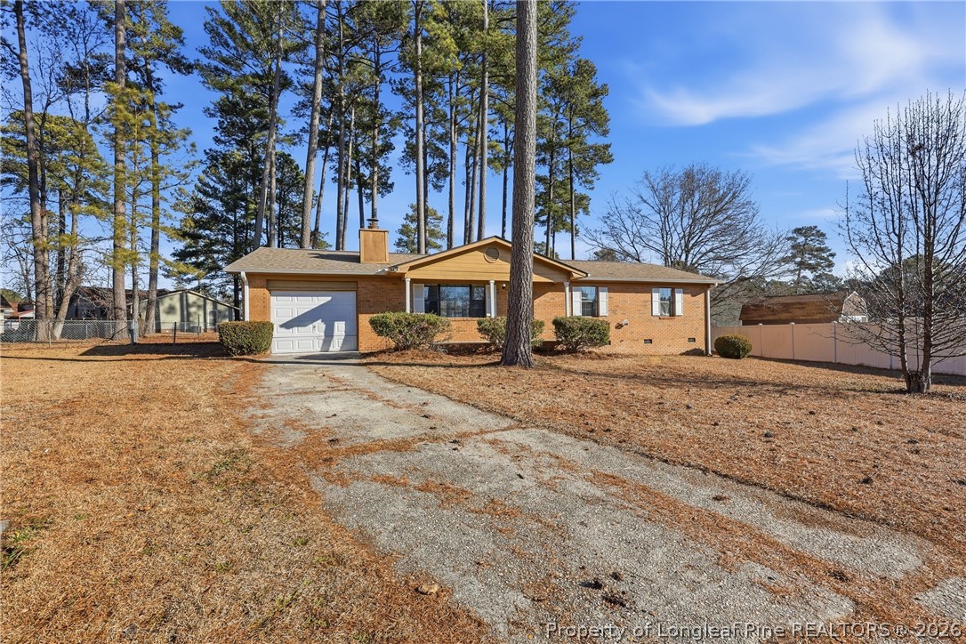 1304 Chara Court Spring Lake, NC 28390 - Photo 2 of 33 a front view of a house with a yard and trees