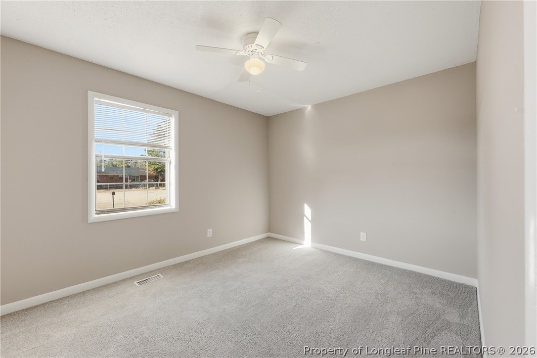 1304 Chara Court Spring Lake, NC 28390 - Photo 22 of 33 an empty room with a window and a ceiling fan
