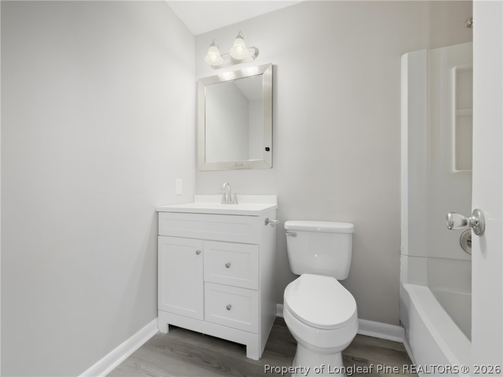 1304 Chara Court Spring Lake, NC 28390 - Photo 25 of 33 a bathroom with a toilet sink and mirror