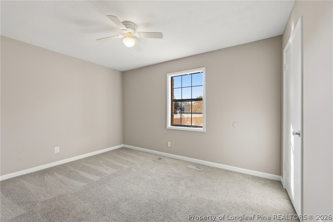 1304 Chara Court Spring Lake, NC 28390 - Photo 26 of 33 an empty room with a window and a ceiling fan