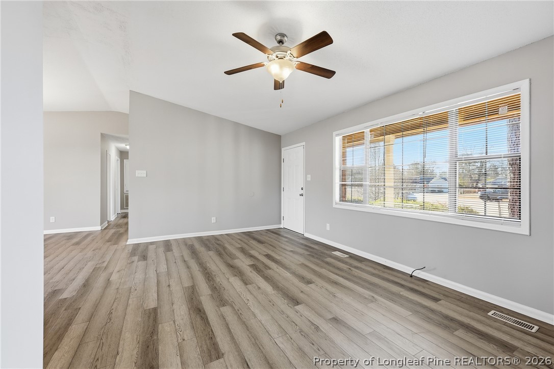1304 Chara Court Spring Lake, NC 28390 - Photo 8 of 33 wooden floor in an empty room with a window