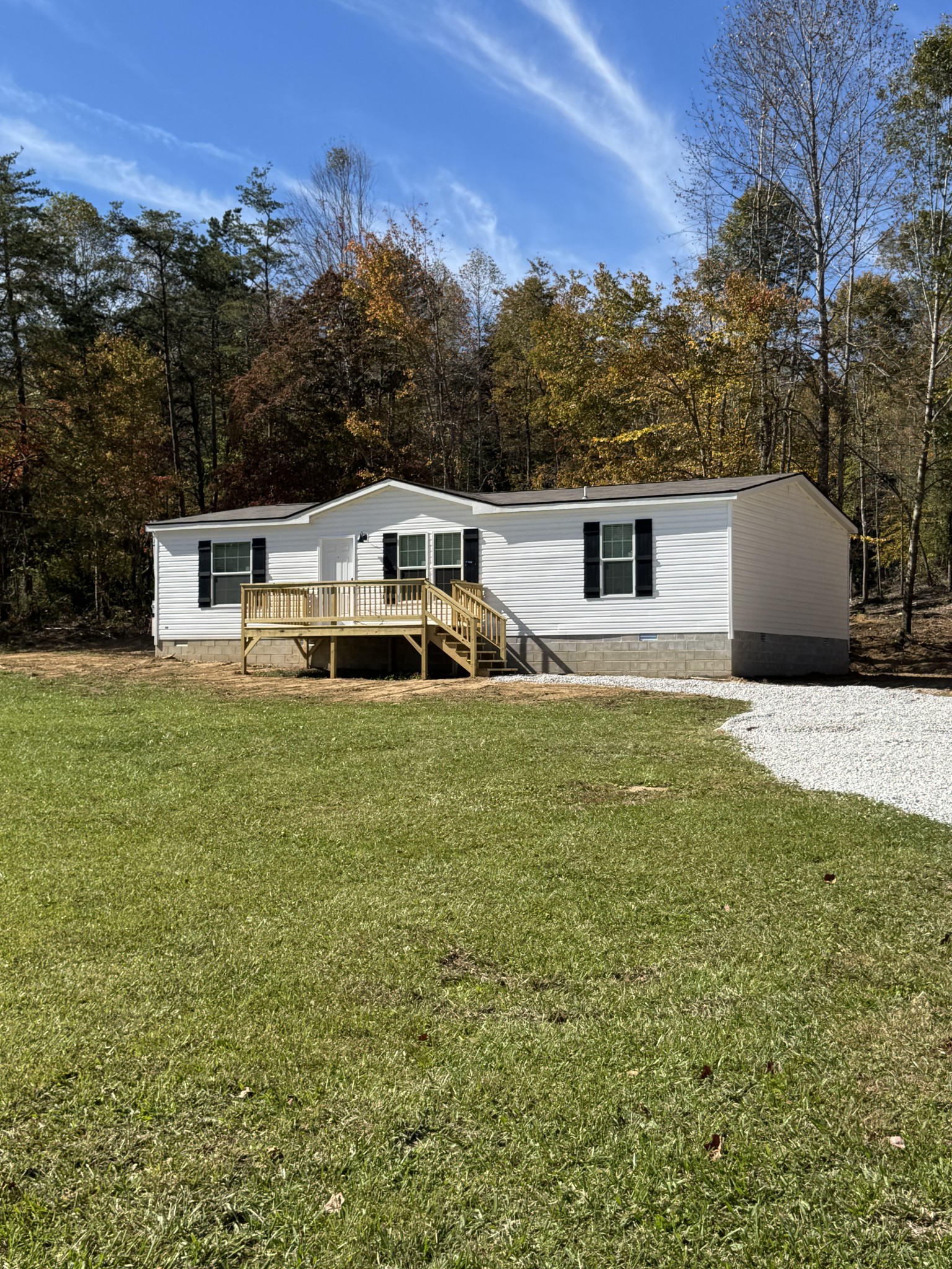 2066 Anderson Road Monterey, TN 38574 - Photo 2 of 18 a white house that has a big yard with wooden fence