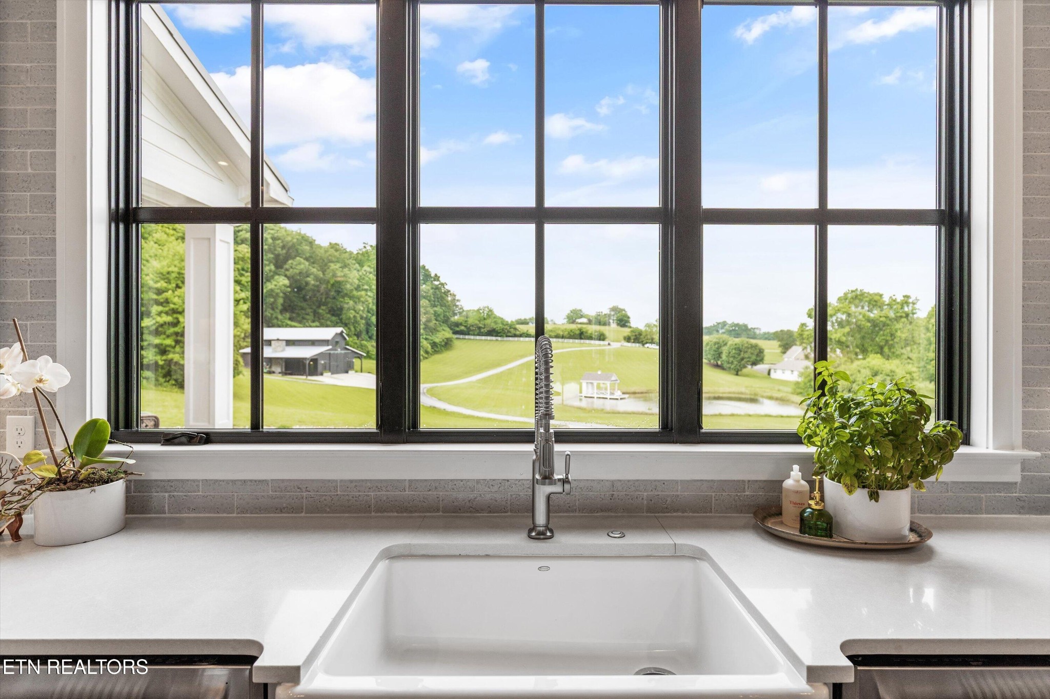 1748 Raulston Road Maryville, TN 37803 - Photo 14 of 59 a kitchen with a large window and a potted plant